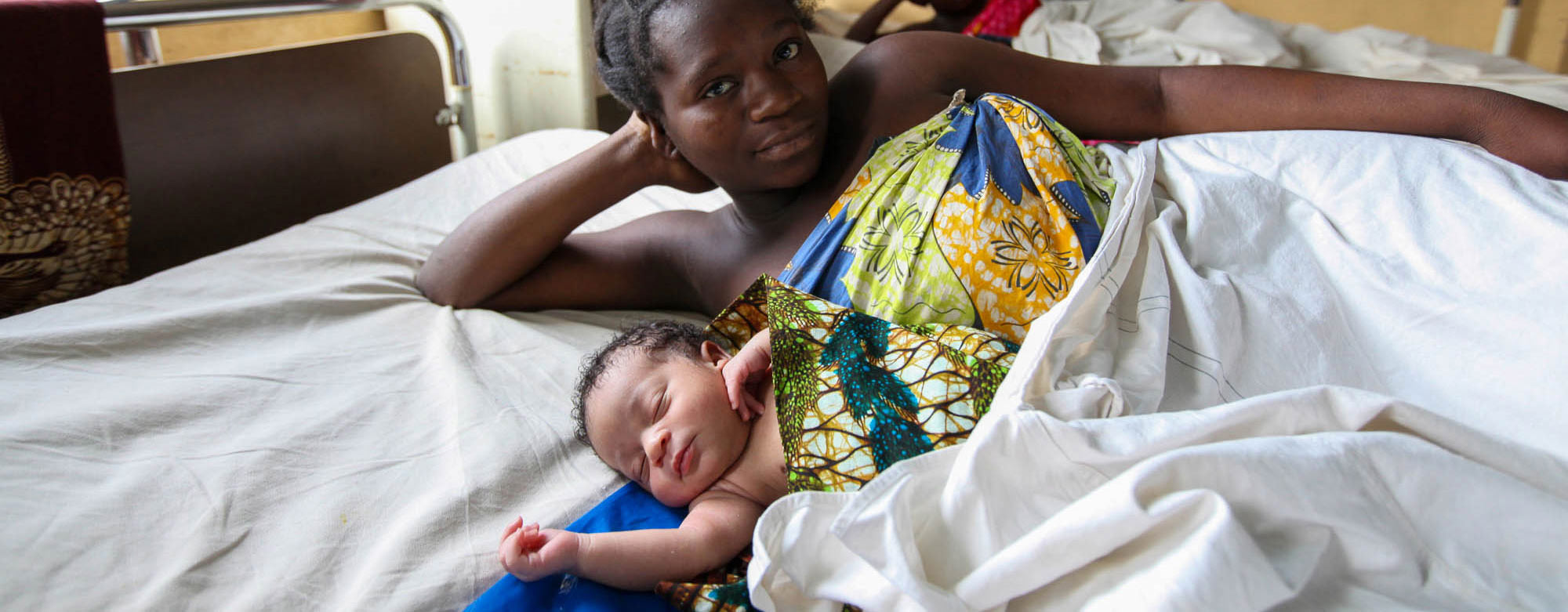 Mother with newborn in hospital bed