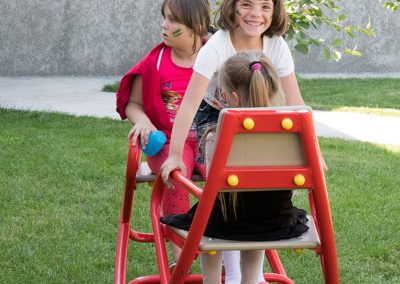 three girls on a seesaw