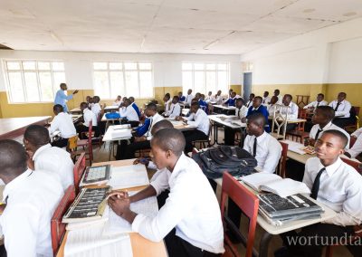 large classroom with many students in school uniform