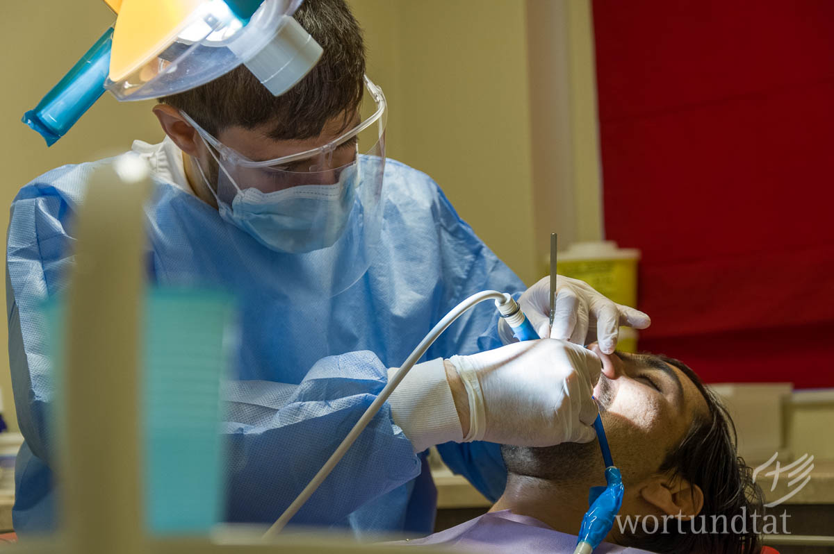 Dentist treats patient - refugees in Greece